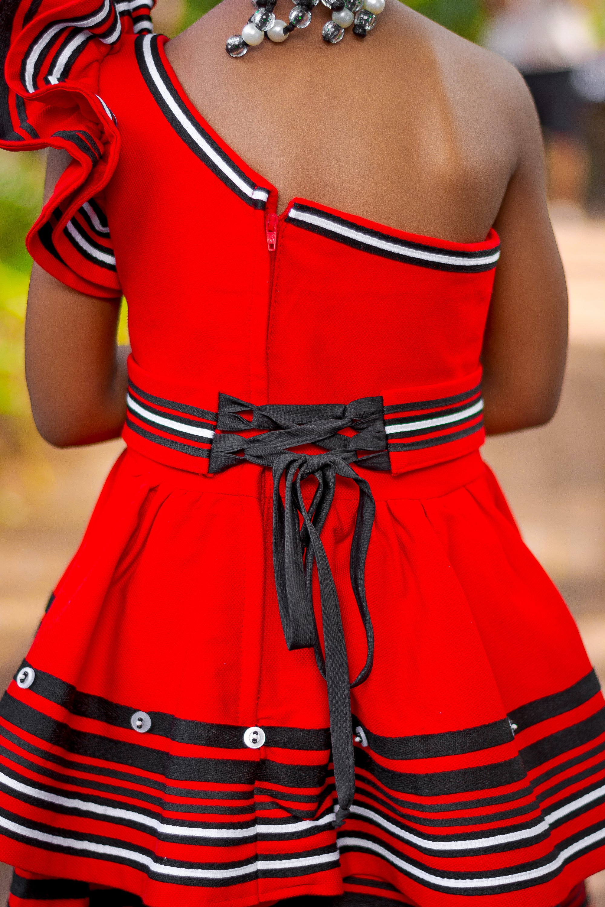 Red frilly one arm girls dress